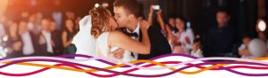 Bride and groom kissing during wedding dance at the John Godber Centre