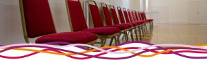 Close up of red chairs in the Main Hall at the John Godber Centre, Hucknall, Notts